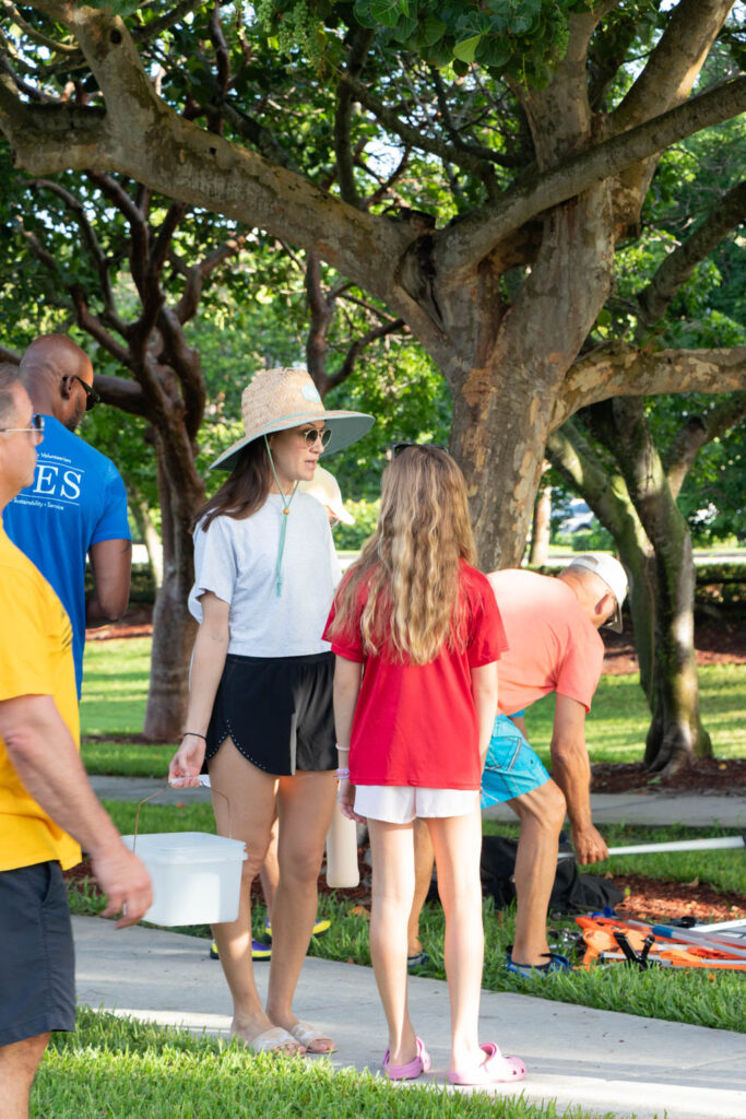 Volunteer standing in the park near the beach cleanup pavilion.