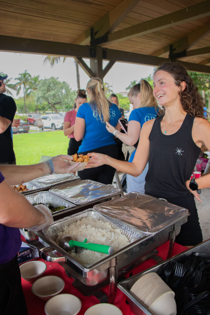 Volunteer receiving Bolay at beach cleanup.
