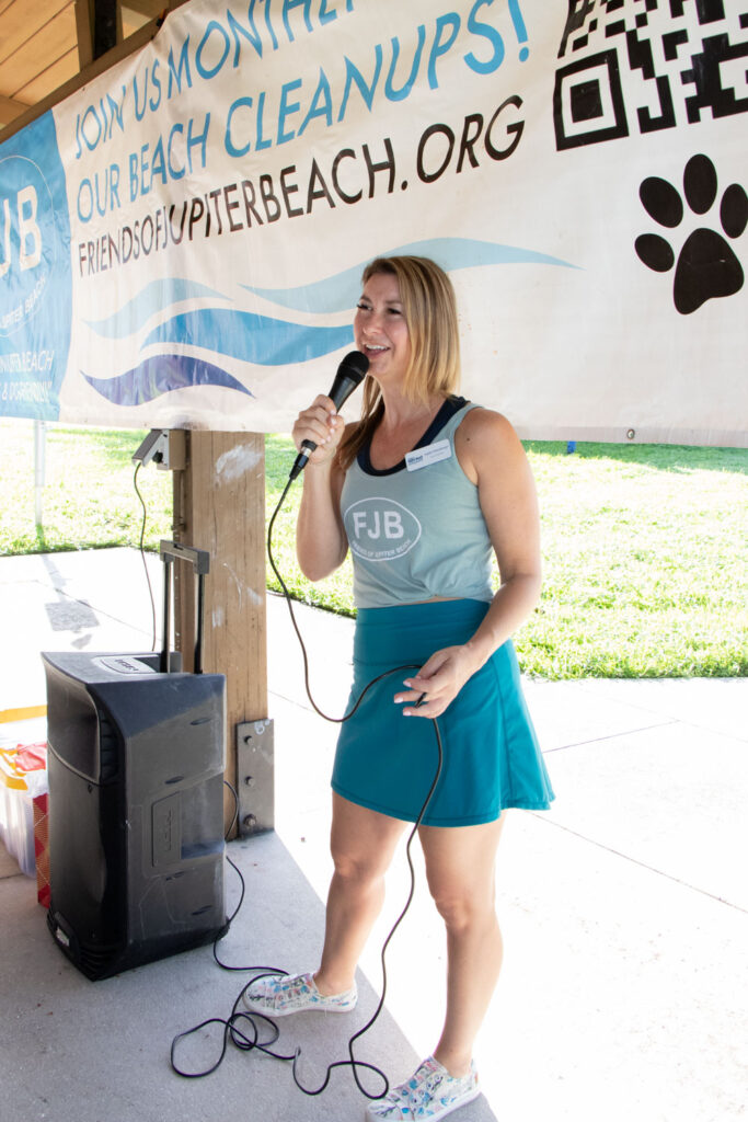 Friends of Jupiter Beach volunteer speaking into a microphone.
