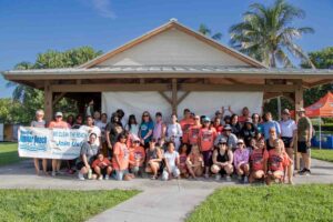 Large group of volunteers standing in front of Anita Lankler Pavilion in Jupiter.