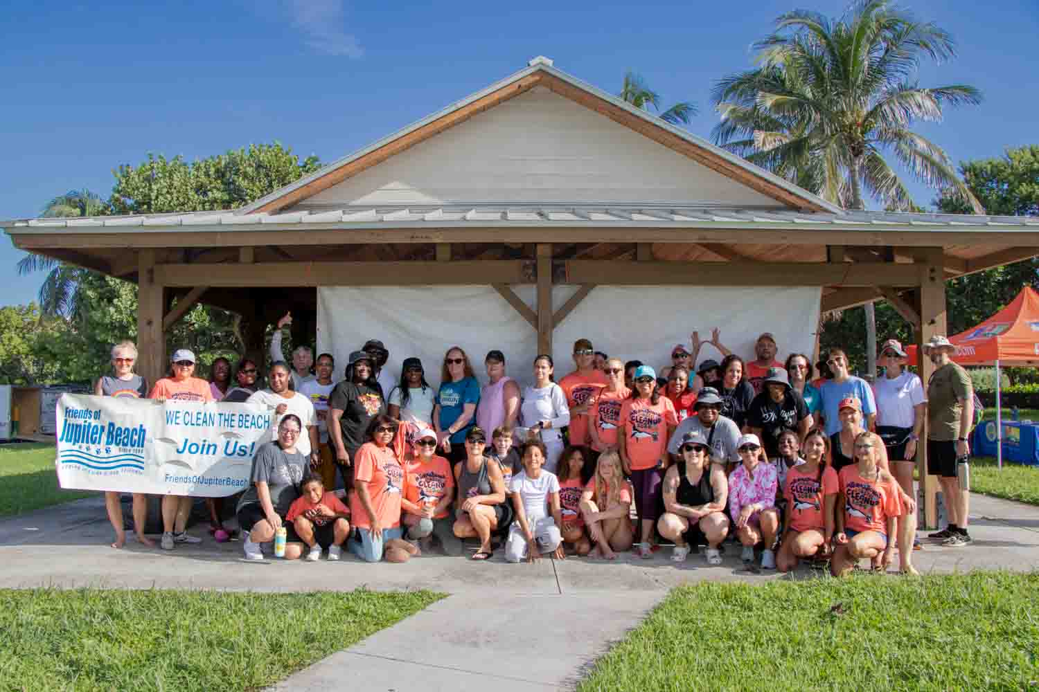 Large group of volunteers standing in front of Anita Lankler Pavilion in Jupiter.