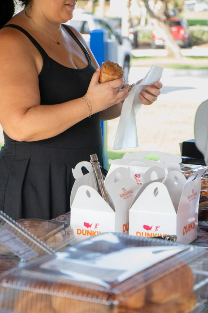 Cleanup volunteer grabbing muffin from breakfast buffet.