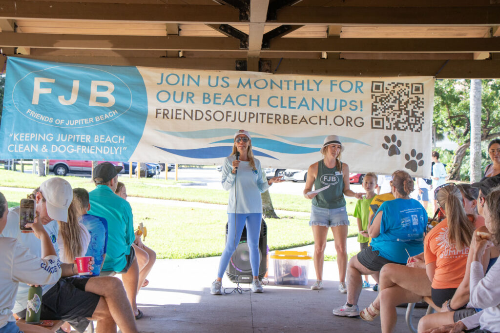 Friends of Jupiter Beach volunteer speaking on the microphone.