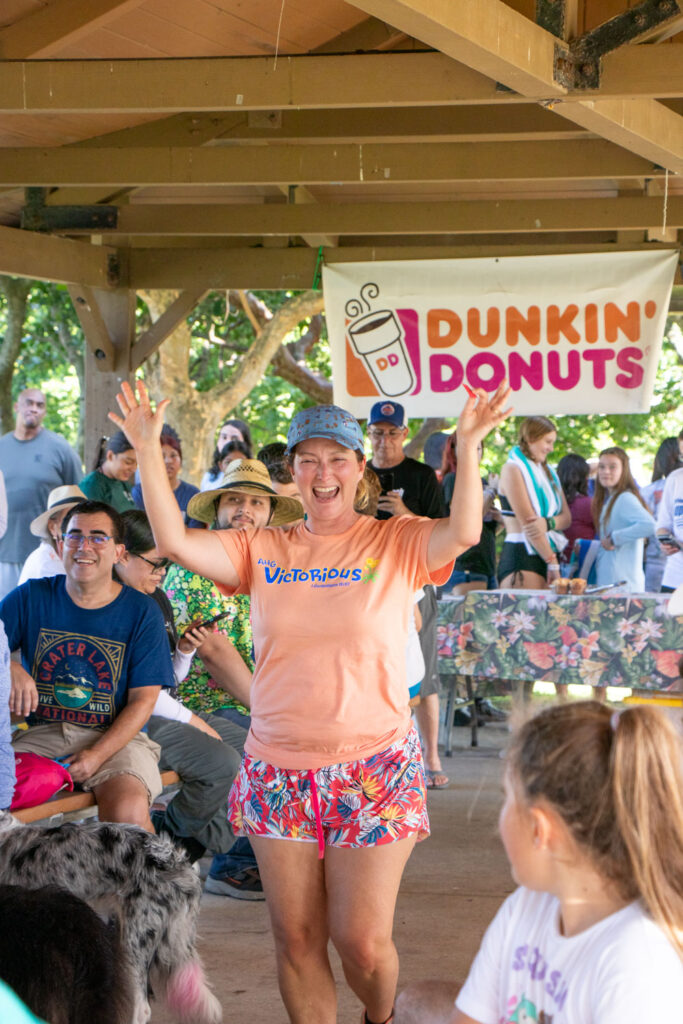 Friends of Jupiter Beach raffle winner smiling and cheering with her arms.