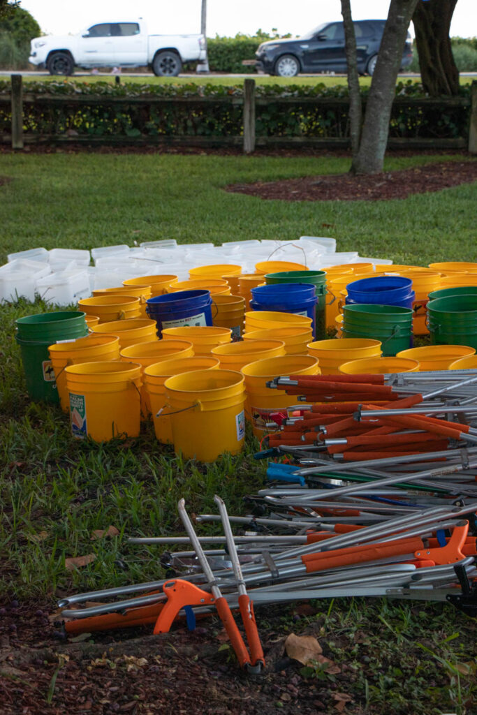 Beach cleanup supplies on the grass.